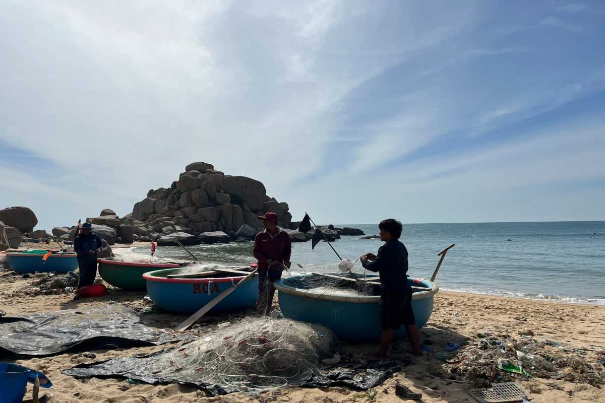 Beach Village Life with Fishing Boats at Binh Tien Beach Fishing boats docked at the shore with village life backdrop at Binh Tien Beach, Ninh Thuận