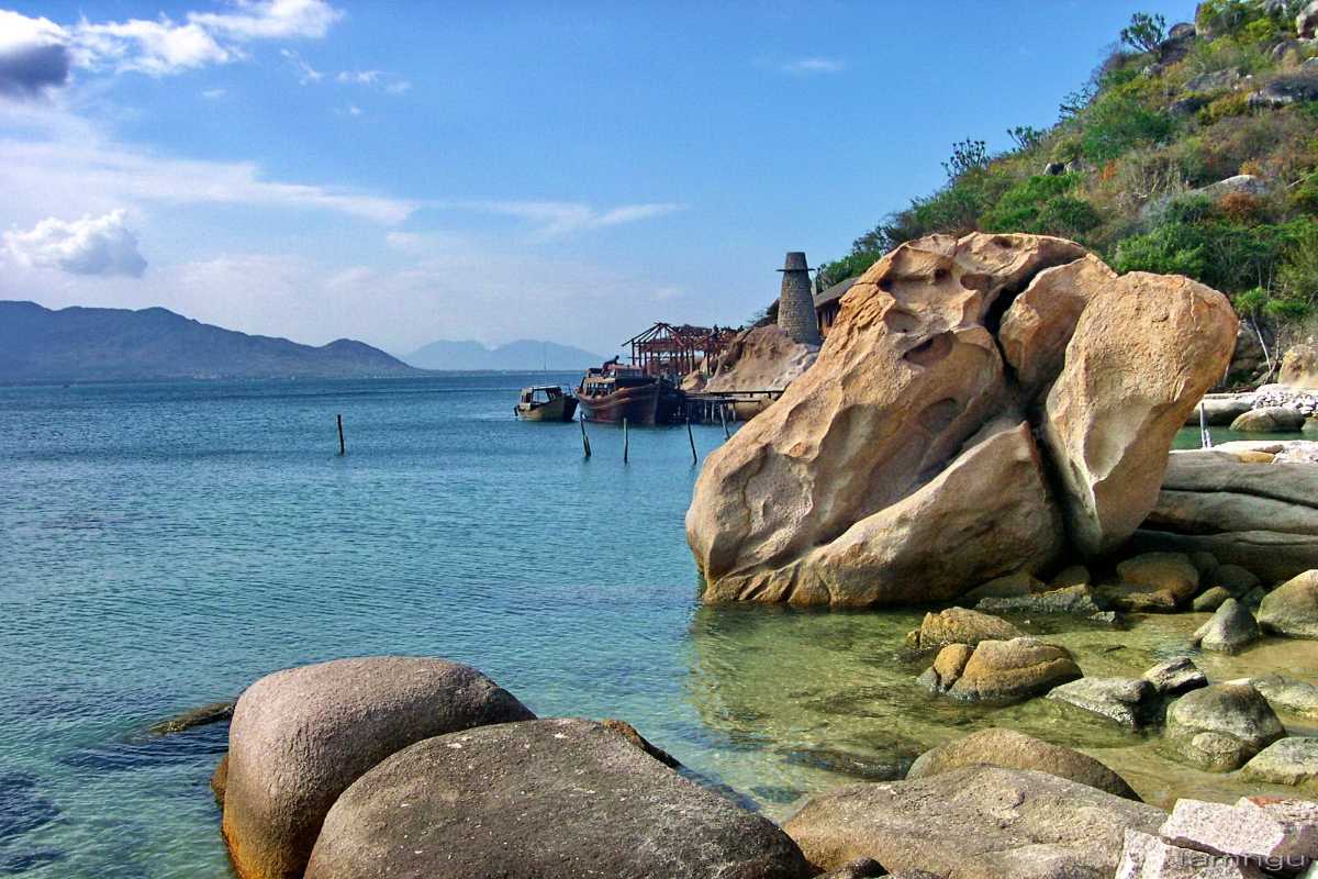Long Curved Sandy Beach at Binh Tien Long sandy curve of Binh Tien Beach bordered by gentle waves and blue skies