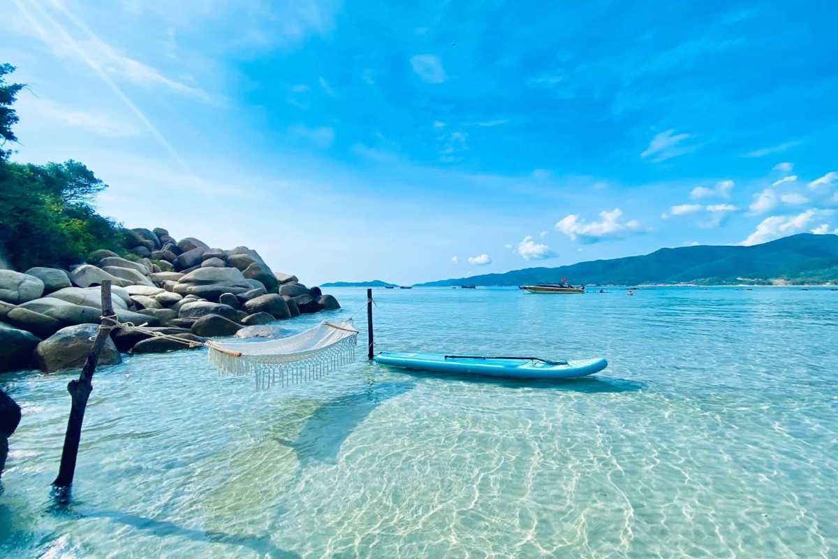Panorama of Binh Tien Beach with clear blue sea and lush green mountains in Ninh Thuận