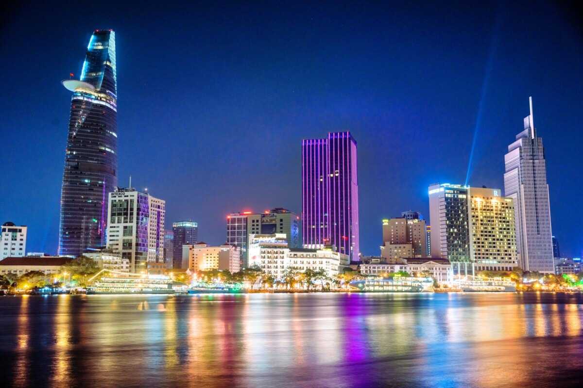 Night View of Bitexco Tower and Ho Chi Minh City Skyline Nighttime cityscape featuring Bitexco Tower and illuminated buildings in Ho Chi Minh City