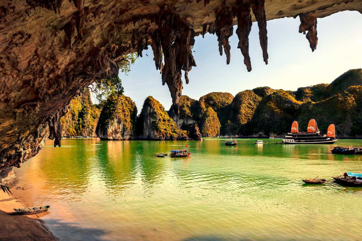 Bo Nau Cave Halong Bay breathtaking limestone islands with boat Bo Nau Cave Halong Bay features dramatic limestone islands and clear blue waters with a traditional boat.