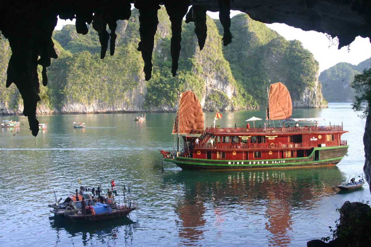 Bo Nau Cave Halong Bay framed by cave opening Bo Nau Cave Halong Bay framed by natural cave formations, with crystal-clear waters and towering karsts.