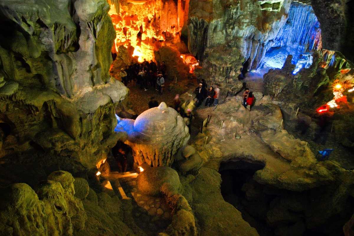 Bo Nau Cave Halong Bay illuminated cave paths with stalagmites The paths inside Bo Nau Cave Halong Bay showcase dramatic stalagmites, highlighted by strategic lighting.