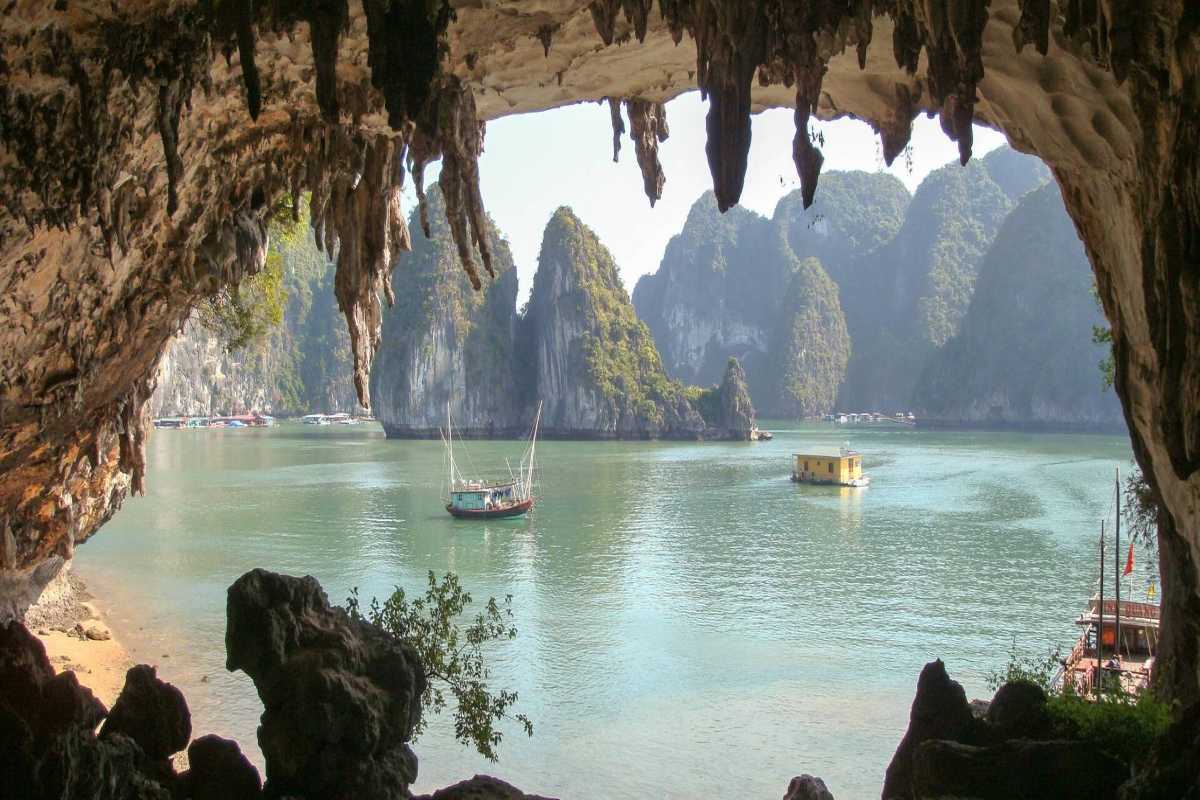 Bo Nau Cave Halong Bay with limestone peaks and boats Bo Nau Cave Halong Bay featuring towering limestone peaks and traditional boats floating in calm waters.