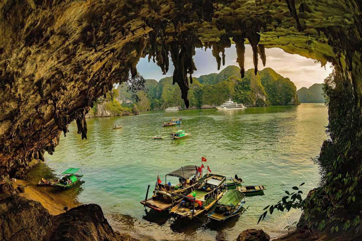 Bo Nau Cave Halong Bay tranquil waters and limestone mountains The view from Bo Nau Cave Halong Bay reveals tranquil, emerald waters framed by towering limestone peaks.
