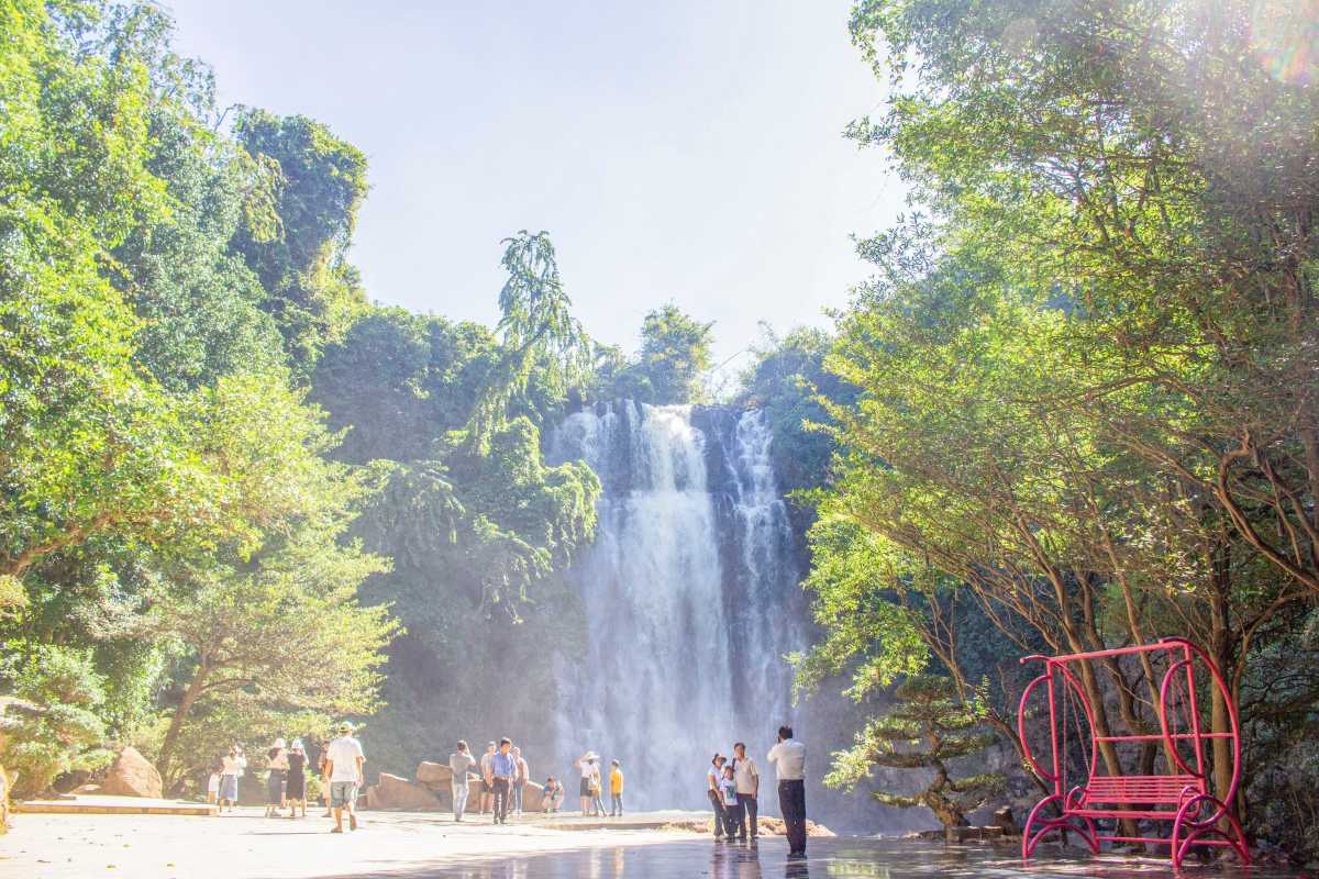 Bobla Waterfall Da Lat scenic waterfall with clear sky Scenic view of Bobla Waterfall Da Lat with blue skies and lush trees surrounding the cascading water