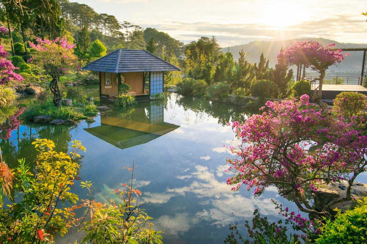 Bobla Waterfall Da Lat tranquil garden with pond Serene garden pond with flowers and a small pavilion reflecting in the water near Bobla Waterfall Da Lat