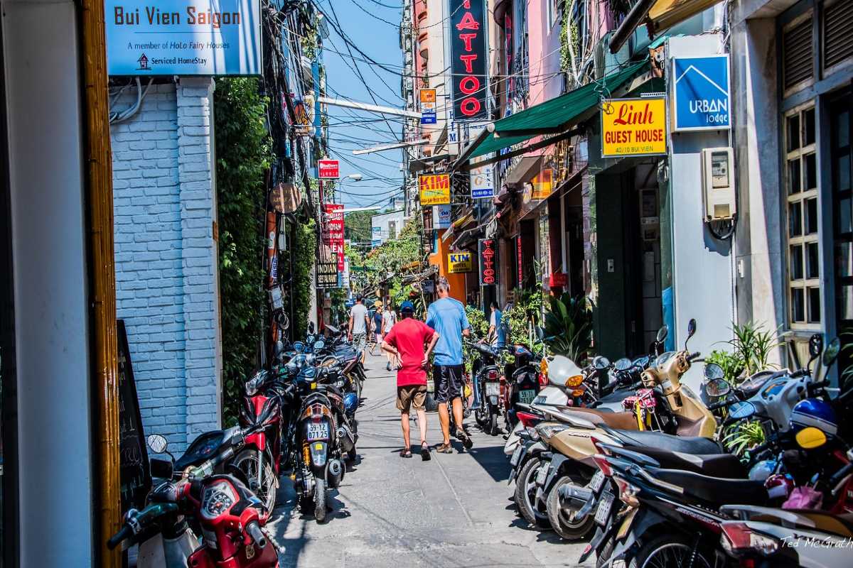 Daytime Walk on Bui Vien Street Pedestrians and motorbikes on a sunny day walking along Bui Vien Street in Ho Chi Minh City.