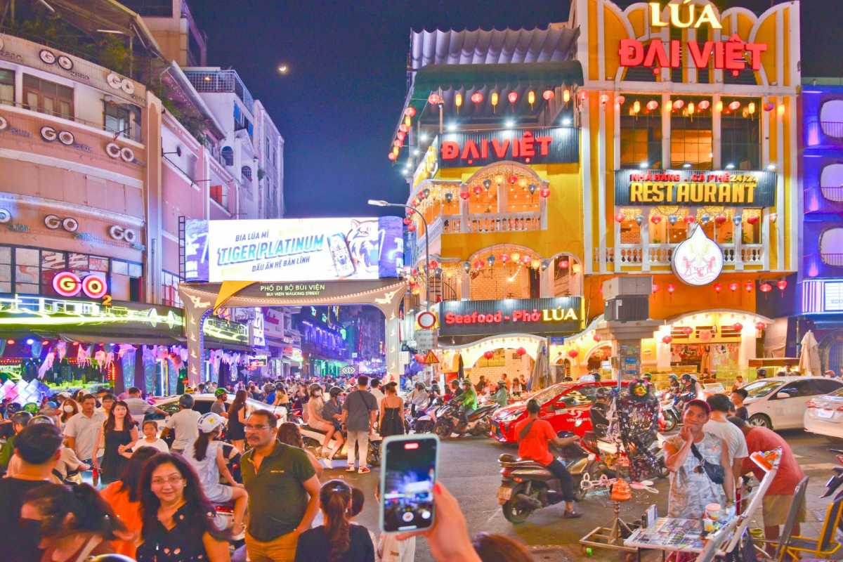 Vibrant Nightlife on Bui Vien Street Ho Chi Minh City Crowded Bui Vien Street in Ho Chi Minh City bustling with people, neon signs, and nightlife.