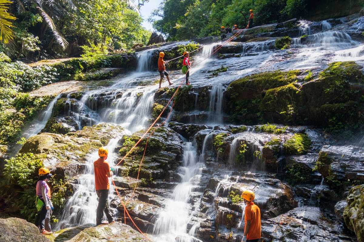 Cam Ly Waterfall Da Lat showing adventure activities with people rappelling down the cascade of flowing water