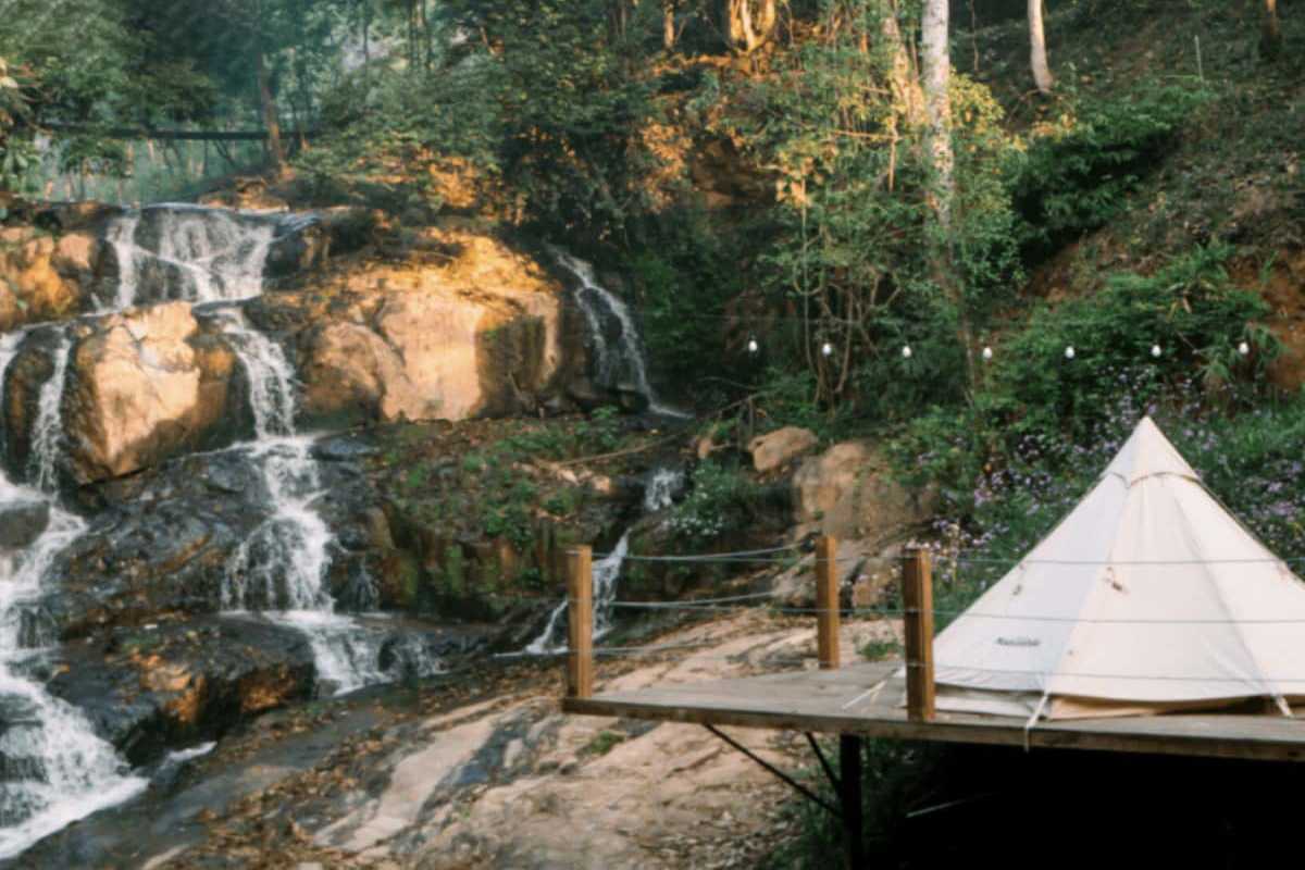 Cam Ly Waterfall Da Lat glamping tent by waterfall Cam Ly Waterfall Da Lat with glamping tent set near the waterfall and forest surroundings