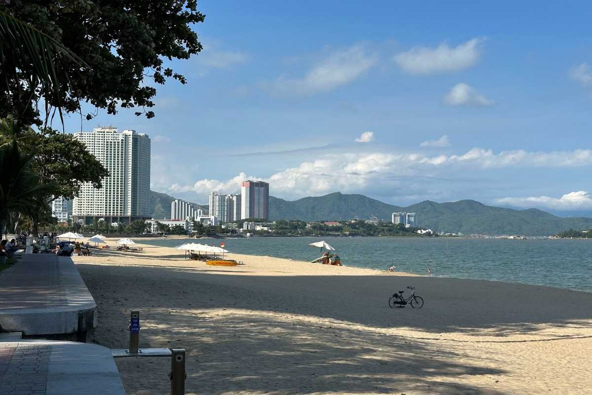 Cam Ranh Bay City and Beach View Beachfront area and cityscape of Cam Ranh Bay with sandy shore and buildings
