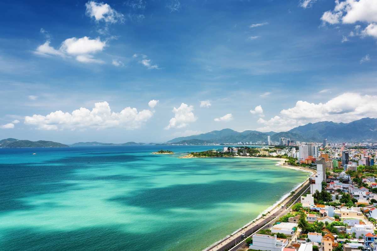 Cam Ranh Bay Turquoise Water and Beach Clear turquoise waters and white sandy beach with palm trees at Cam Ranh Bay