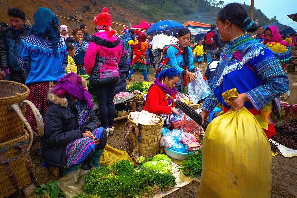 Fresh produce vendors at Can Cau Market with Hmong people selling vegetables