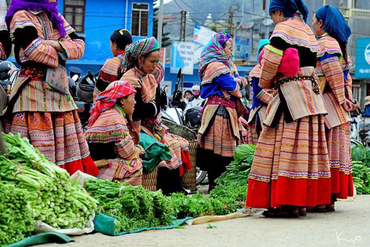 Ethnic women in traditional clothing selling fresh produce at Cao Son Market, Muong Khuong district