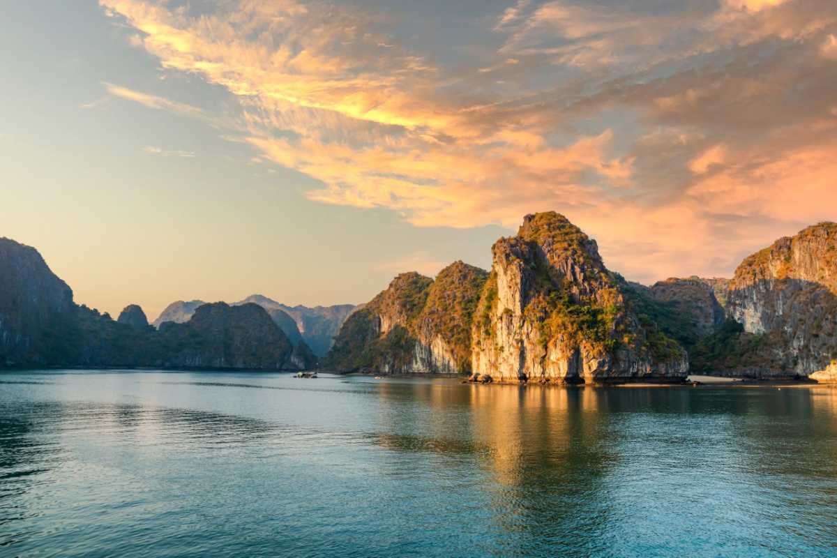 Cap La Island Bai Tu Long Bay kayaking group Group kayaking in the emerald waters of Cap La Island in Bai Tu Long Bay amidst towering karsts