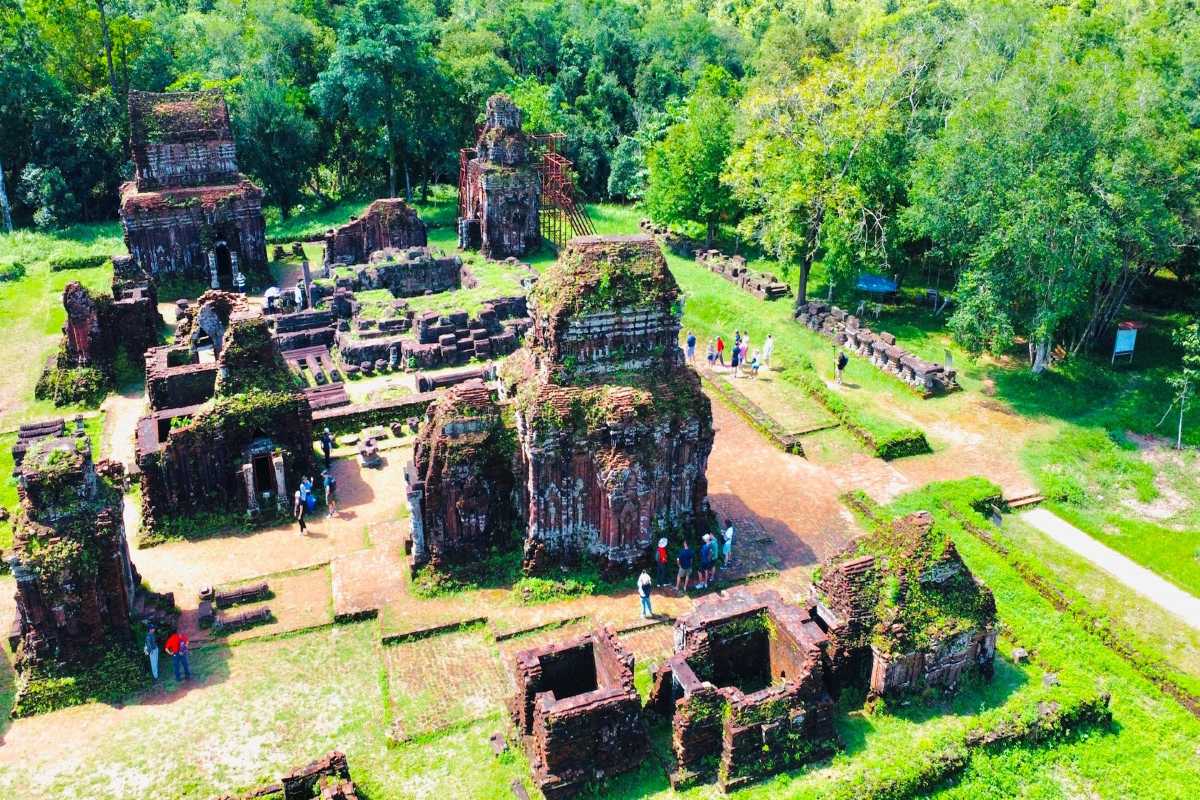 Cham Cultural Performance at My Son Sanctuary Traditional Cham dancers in colorful attire performing amidst the ancient temple ruins at My Son Sanctuary Vietnam