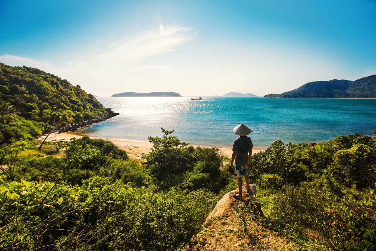 Scenic View of Cham Islands Coastline and Crystal Waters Panoramic view of the Cham Islands coastline with clear turquoise waters and lush green hills