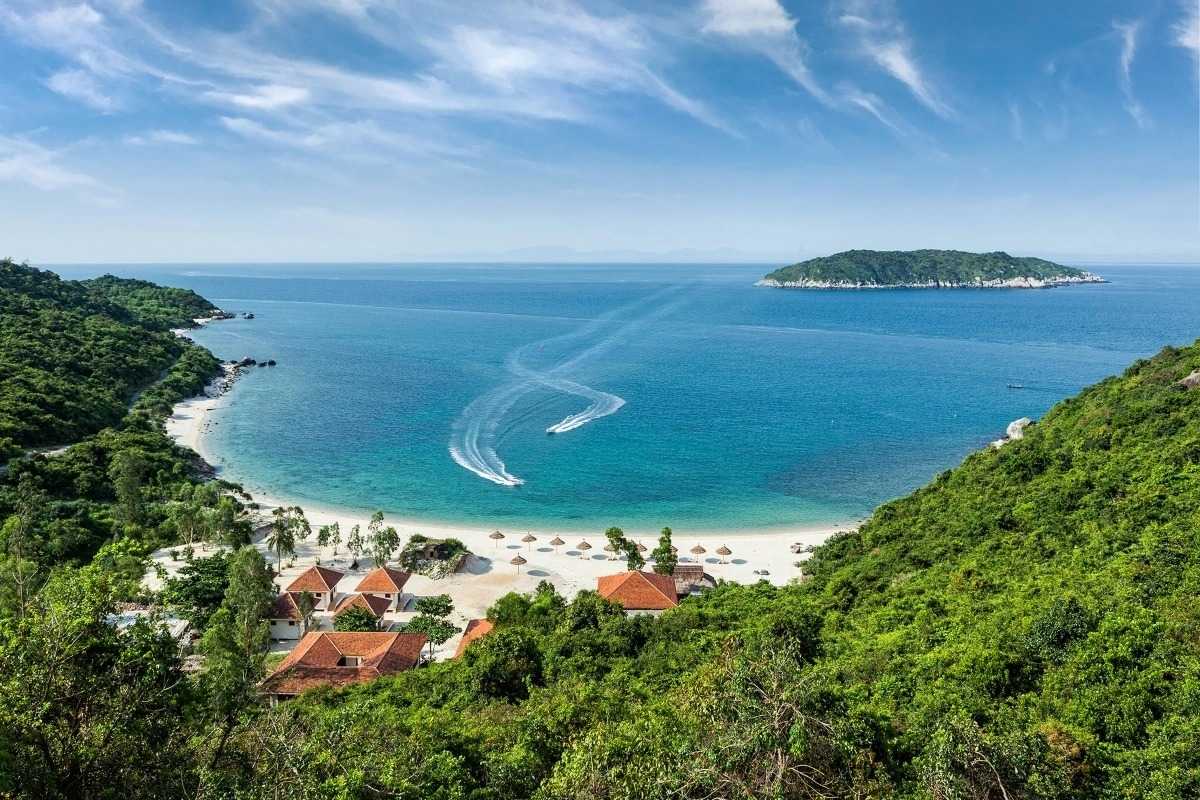Lush Green Hills and Village Landscape on Cham Islands Scenic landscape of green hills and village rooftops at Cham Islands, showcasing natural beauty