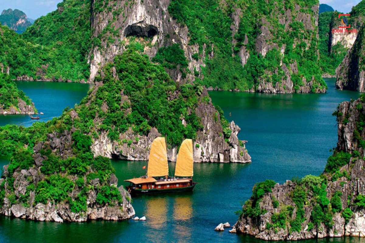 Cho Da Islet Halong Bay traditional boat cruise scene Traditional boat cruising near Cho Da Islet Halong Bay surrounded by towering limestone karsts and emerald waters.