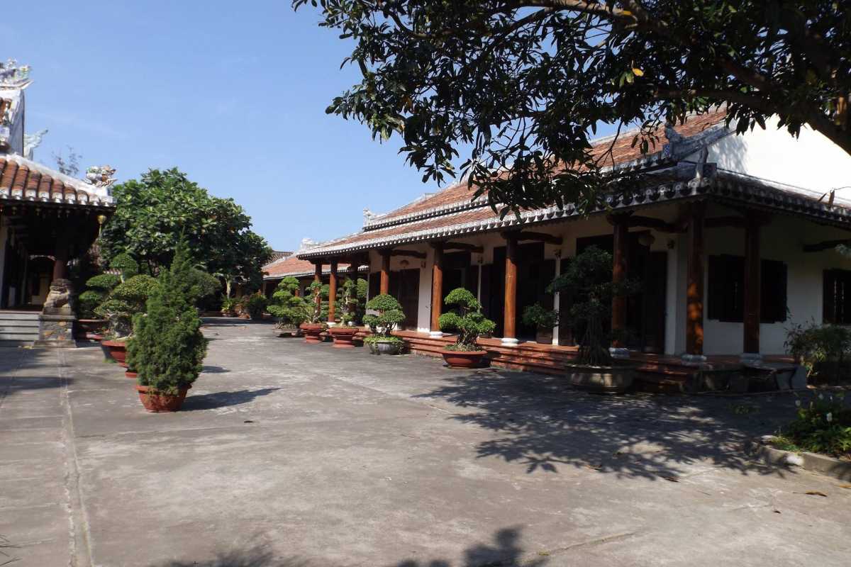 Courtyard and Worship Halls of Chuc Thanh Pagoda Hoi An Spacious courtyard with wooden pillars and worship halls featuring traditional architecture at Chuc Thanh Pagoda