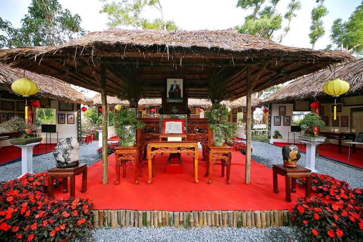 Exhibition Courtyard with Red Carpet and Floral Decorations Open courtyard with red carpet, floral decorations, and Buddhist relics at Chuc Thanh Pagoda in Hoi An