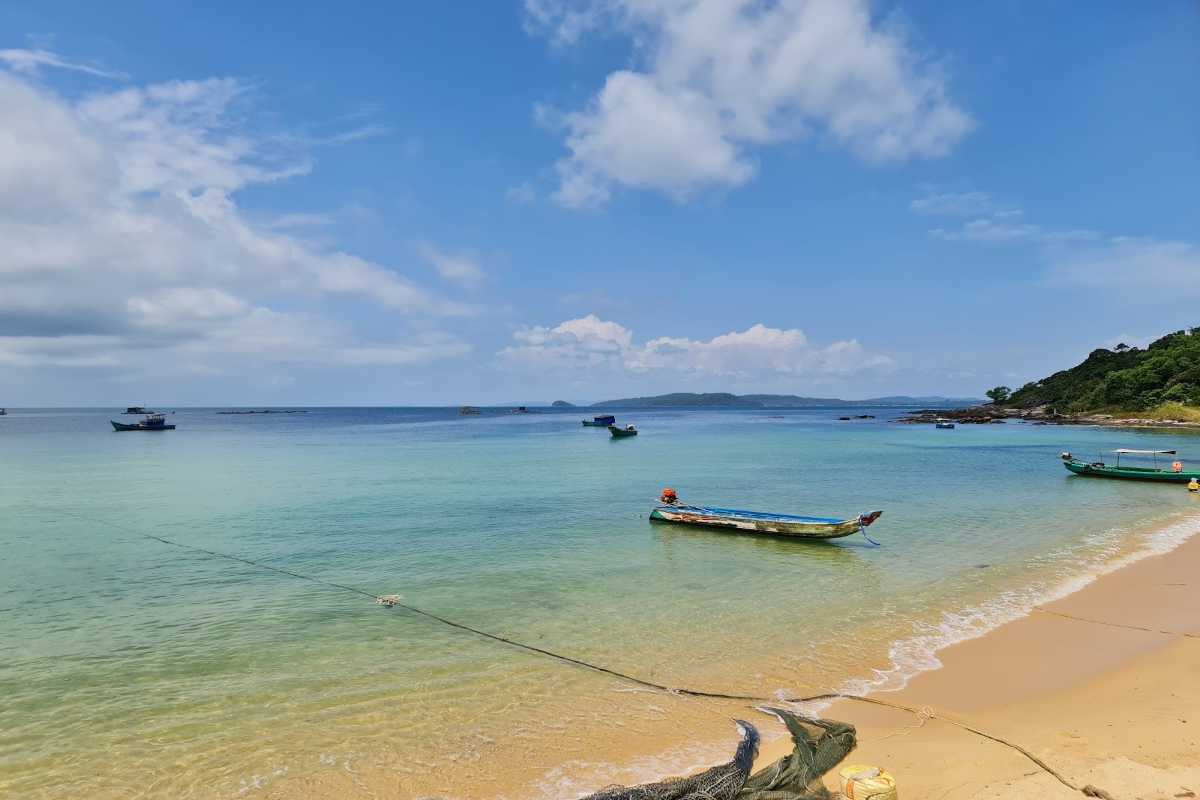 Clear Water at Ganh Dau Cape Crystal-clear waters at Ganh Dau Cape with boats anchored on the shore.