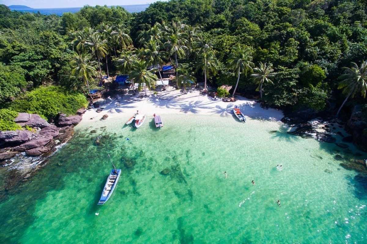 Clear Waters and Boats at May Rut Trong Island Clear turquoise waters with boats floating near the sandy shore of May Rut Trong Island