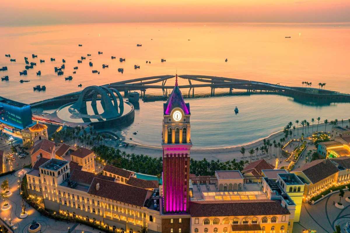 Clock Tower Phu Quoc at Night with Purple Lighting Night scene of Clock Tower Phu Quoc glowing with purple lights by the sea