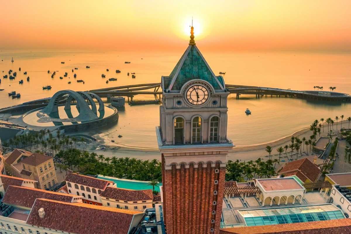 Clock Tower Phu Quoc with Sunrise Background Early morning sun casting golden light over Clock Tower Phu Quoc and nearby structures