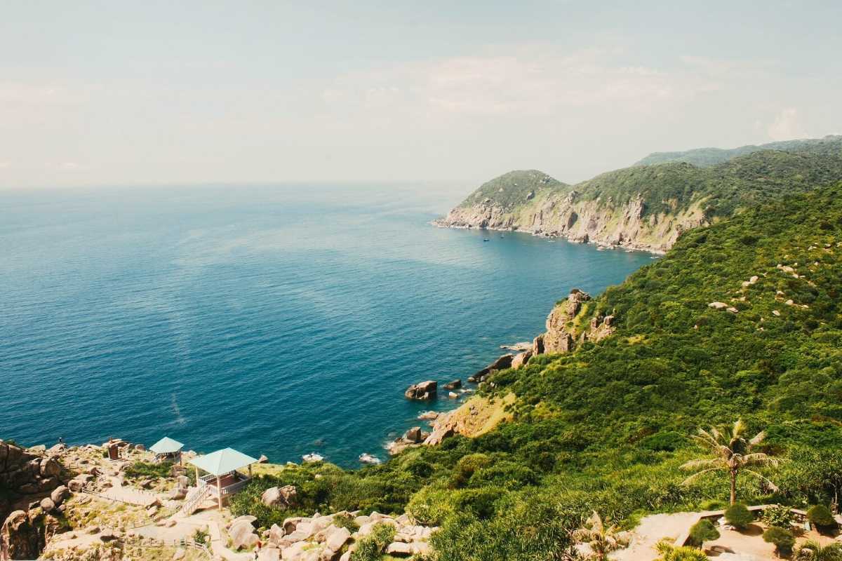 Coastal cliffs and blue ocean views at Dai Lanh Beach Dramatic coastal cliffs and deep blue ocean waters with rocky shoreline at Dai Lanh Beach, Nha Trang