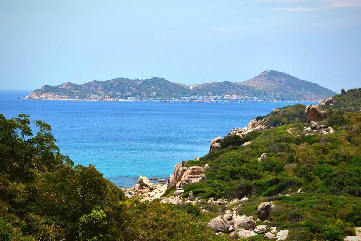 Coastal View with Mountains Phan Rang Ninh Thuan Coastal view showing mountains and sea under clear blue sky in Phan Rang Ninh Thuan
