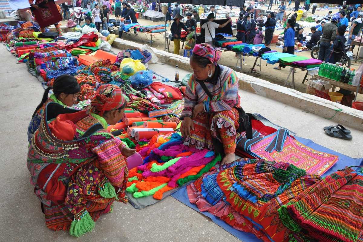 Coc Ly Market Sapa handmade fabric goods vendors Coc Ly Market Sapa vendors selling handmade fabric goods, colorful textiles, and ethnic crafts on market day.