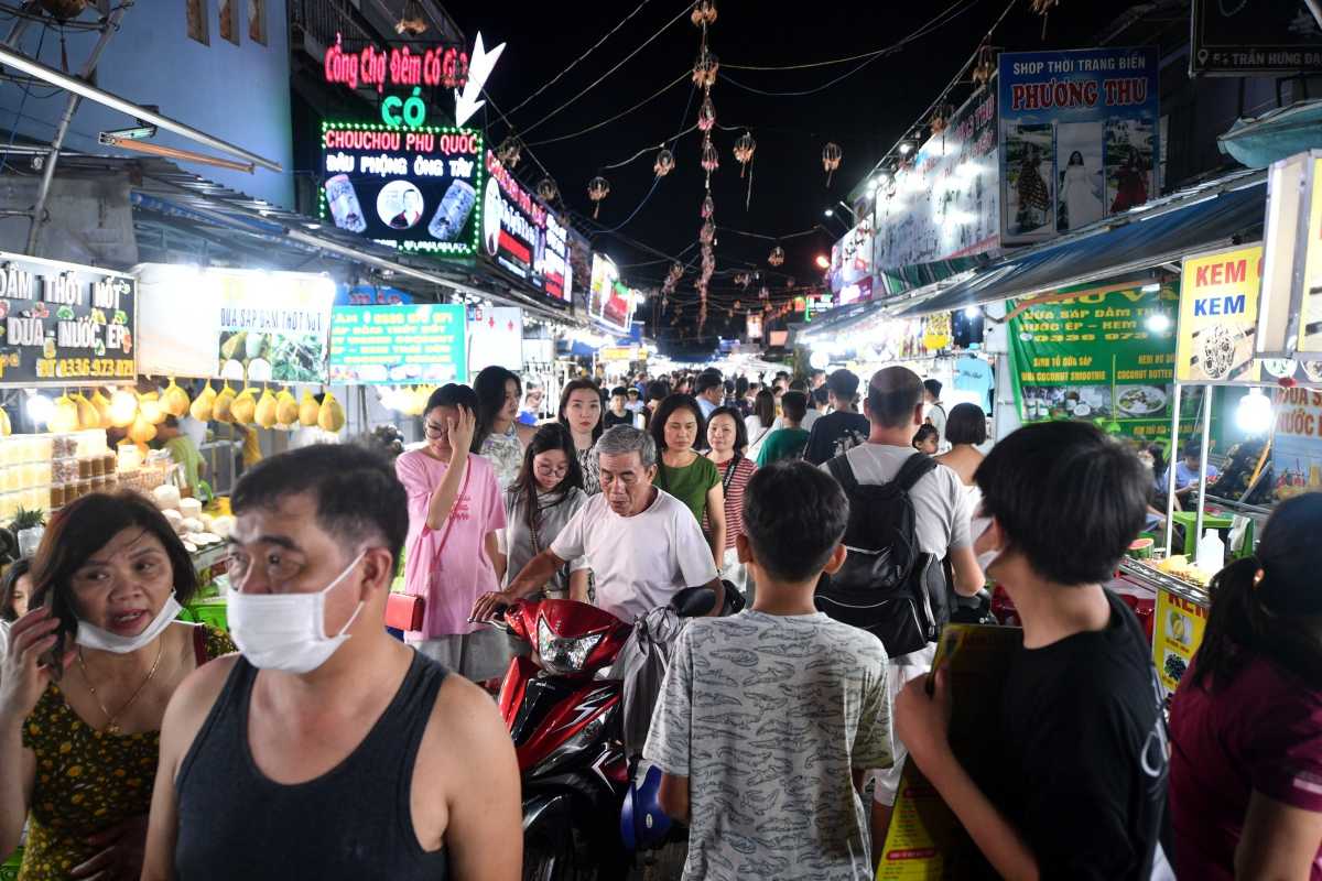 Coconut Ice Cream Stall at Night Market Vendor selling coconut ice cream among other local treats at Duong Dong Night Market