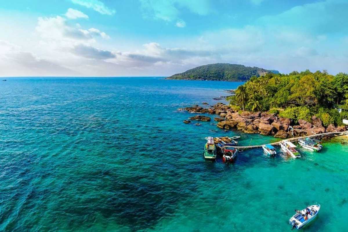 Colorful Pier and Coral Reefs at May Rut Trong Colorful pier extending into turquoise water with coral reefs visible near May Rut Trong Island