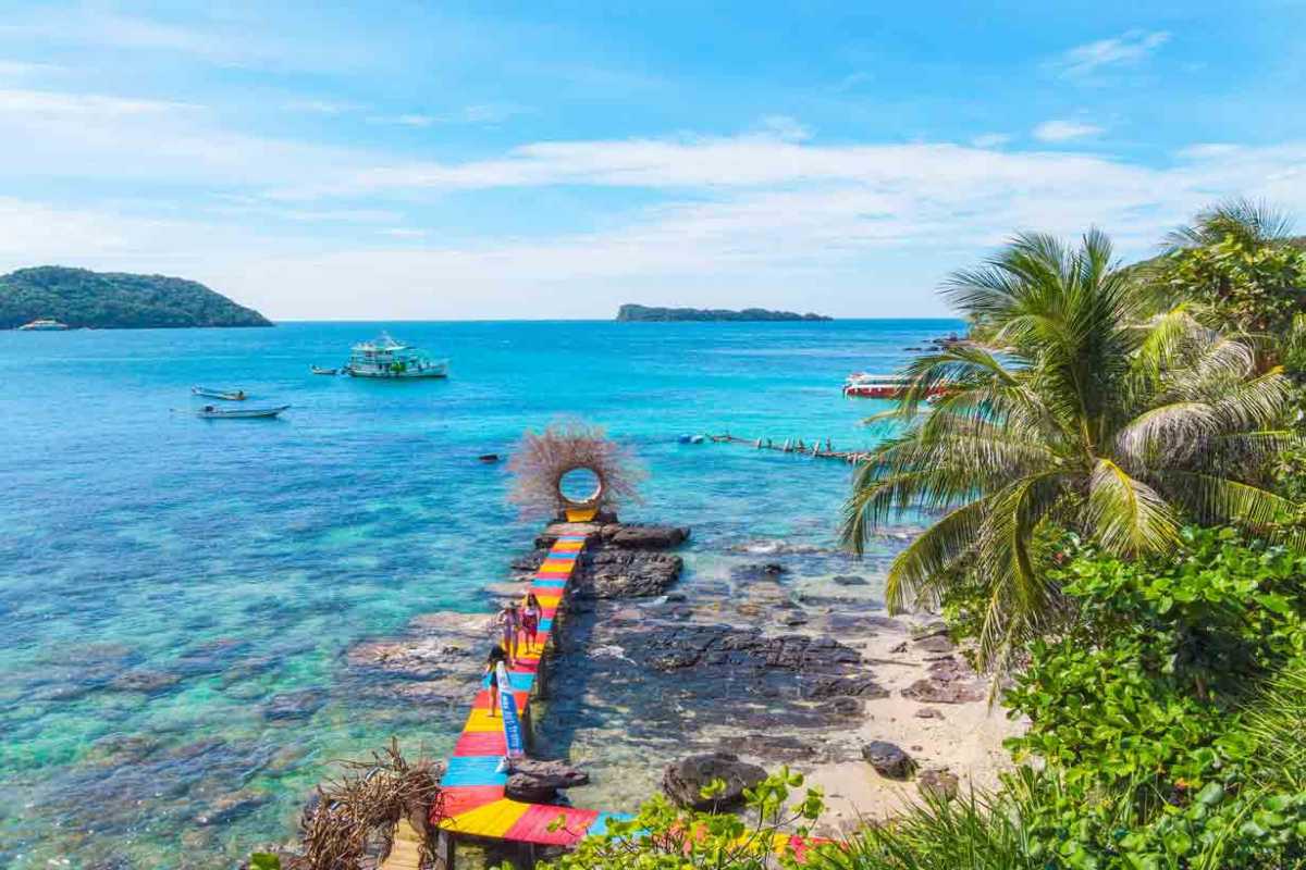 Colorful Pier Leading to May Rut Trong Island Vibrant multicolored pier extending over crystal-clear waters on May Rut Trong Island