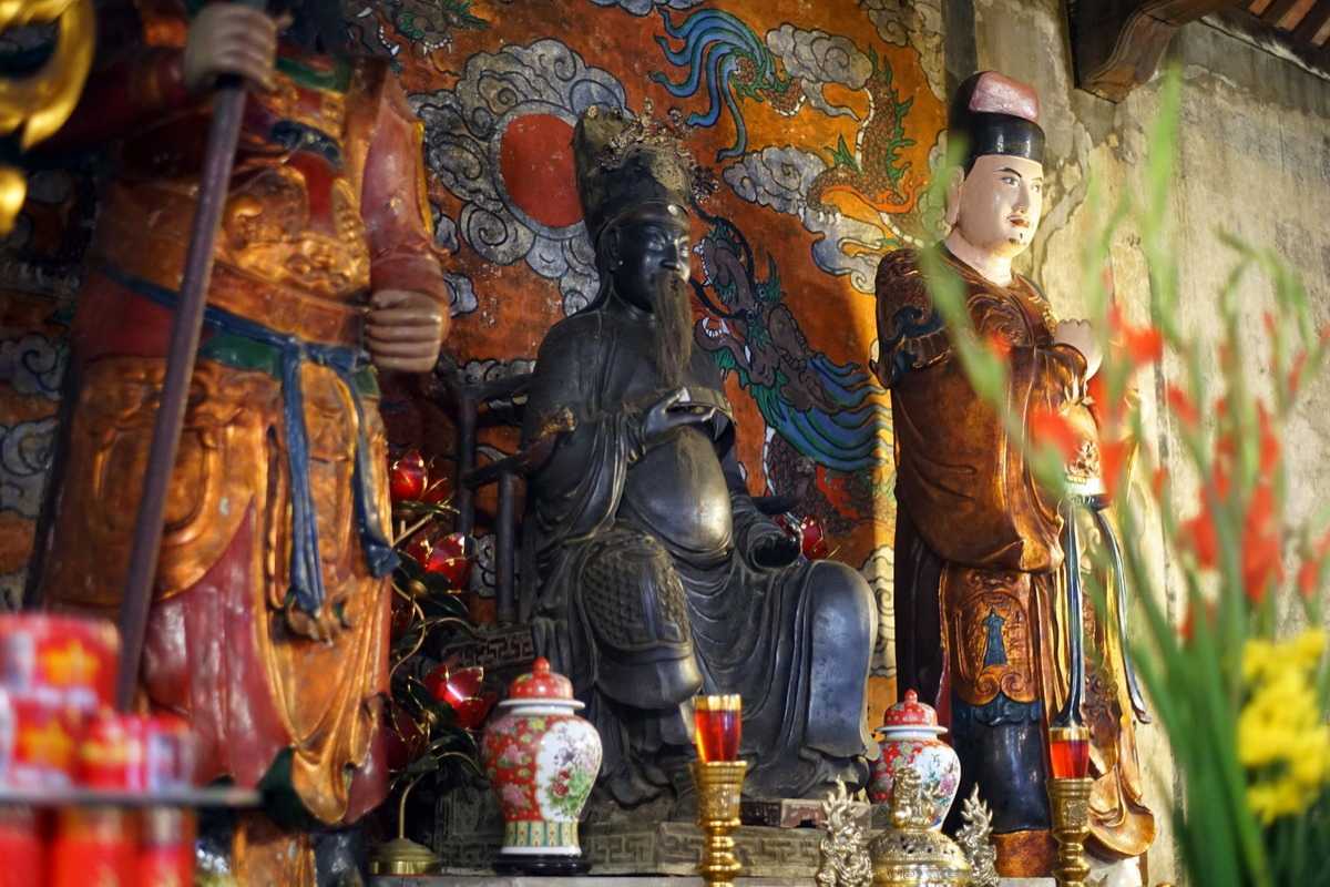 Colorful Religious Statues Inside Quan Thanh Temple Vividly painted statues of deities within Quan Thanh Temple