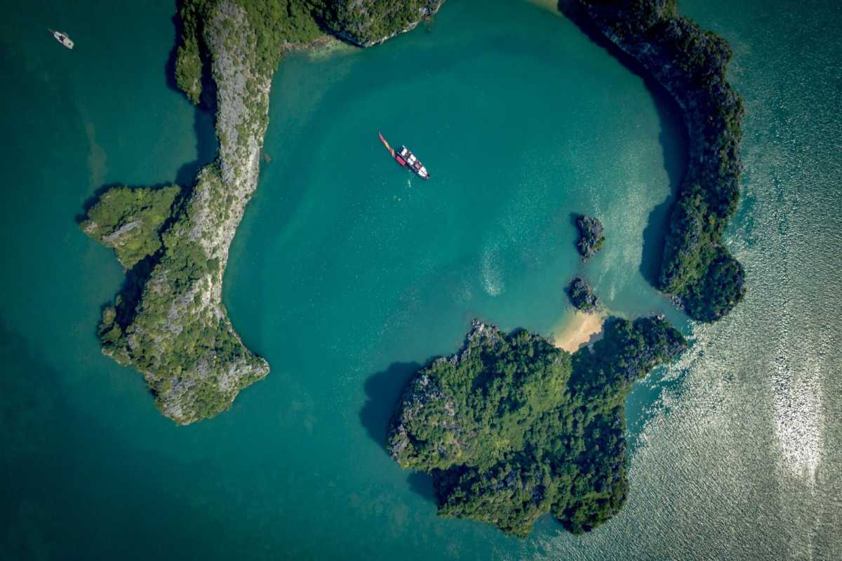 Cong Do Island Bai Tu Long Bay limestone cliffs and floating houses Limestone cliffs and floating houses on emerald waters at Cong Do Island Bai Tu Long Bay