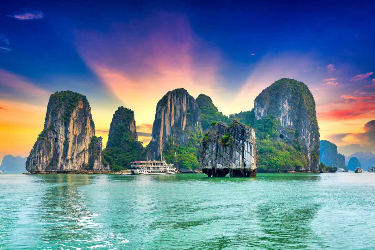 Cong Do Island Bai Tu Long Bay traditional wooden boats Traditional wooden boats moored near the limestone cliffs of Cong Do Island in Bai Tu Long Bay