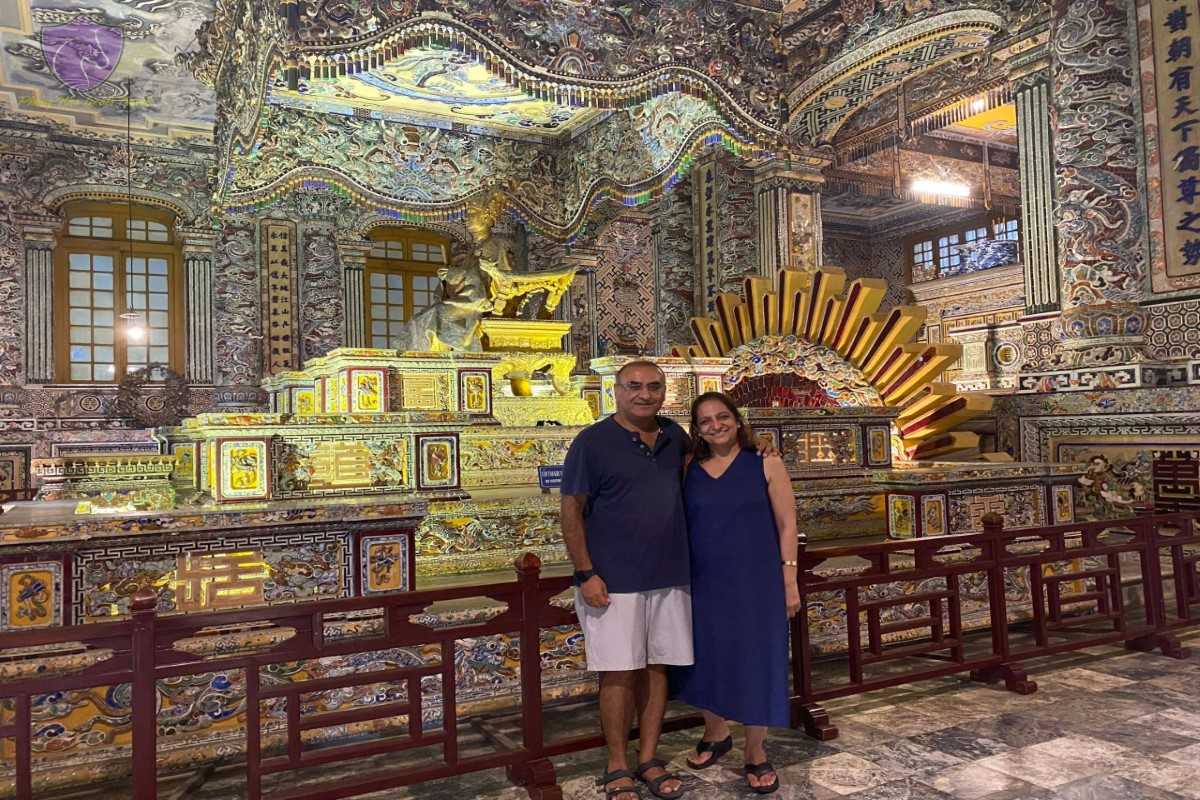Couple inside Thien Dinh Palace at Khai Dinh Tomb Couple posing inside Thien Dinh Palace at Khai Dinh Tomb, surrounded by vivid mosaic walls and statue