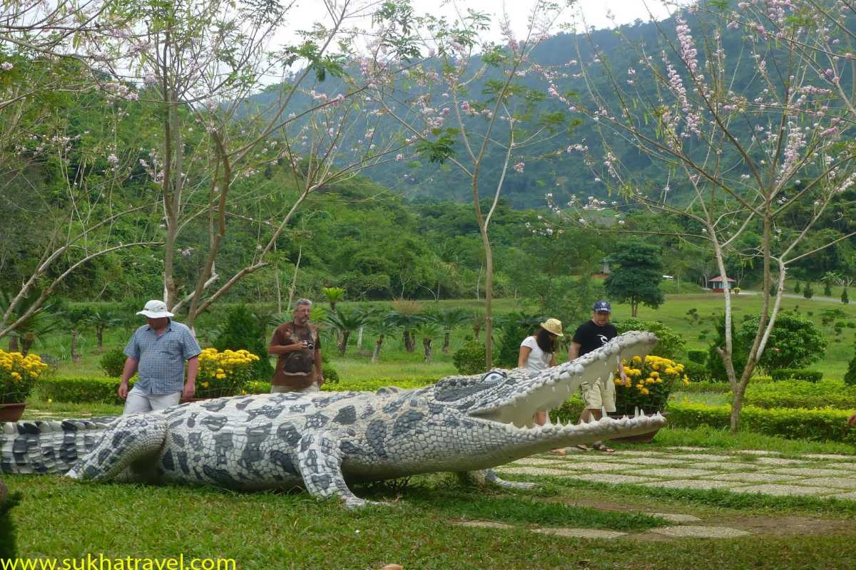 Sculpture display at Crocodile Farm Yang Bay Tourists walking near a giant crocodile sculpture at Crocodile Farm Yang Bay.