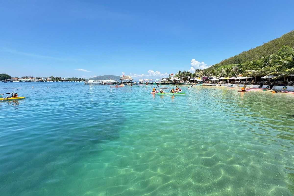 Crystal Clear Waters at Robinson Beach Nha Trang Turquoise crystal clear waters at Robinson Beach Nha Trang with visitors swimming and relaxing on the shore