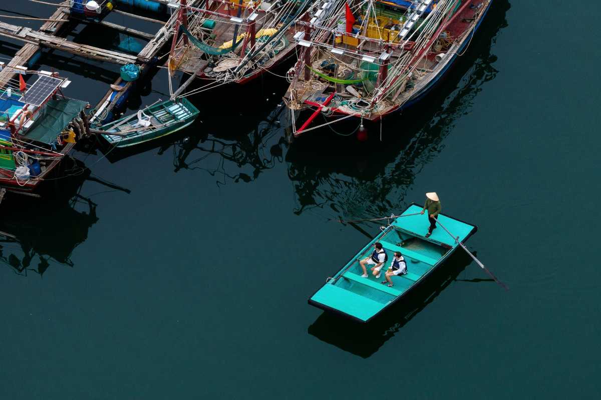 Cua Van Floating Village Halong Bay Traditional Boats Wooden traditional boats docked at Cua Van Floating Village Halong Bay with fishing nets and equipment visible