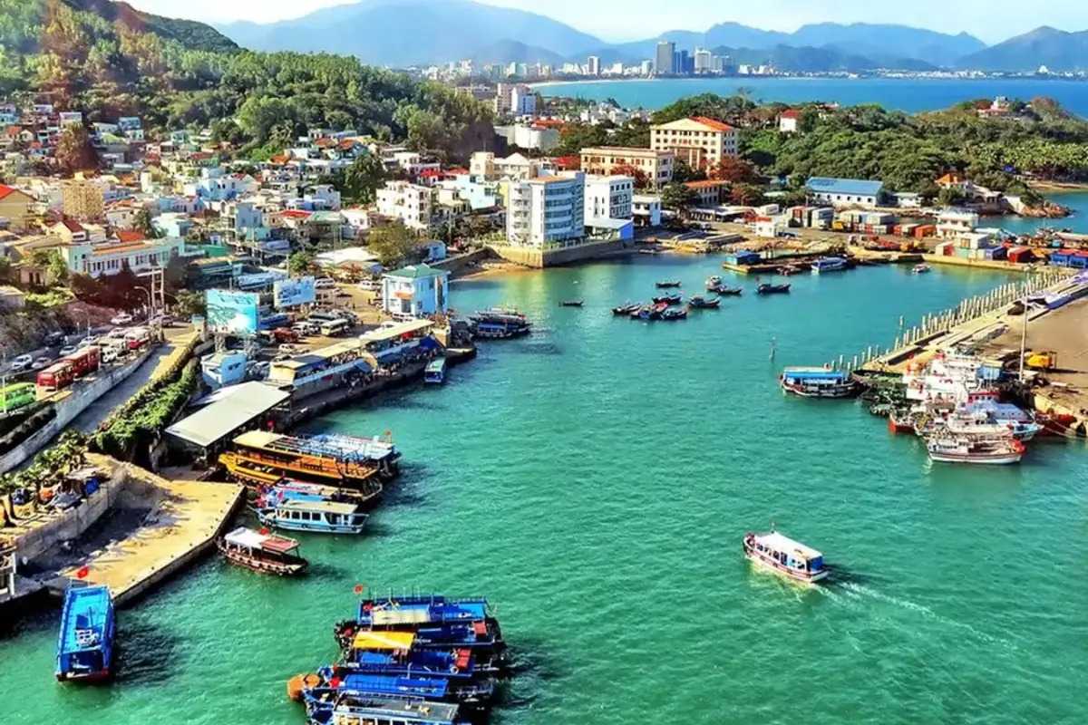 Da Chong Wharf Granite Rocks and Coastal Buildings Nha Trang Granite rock formations with coastal buildings and boats at Da Chong Wharf, Nha Trang