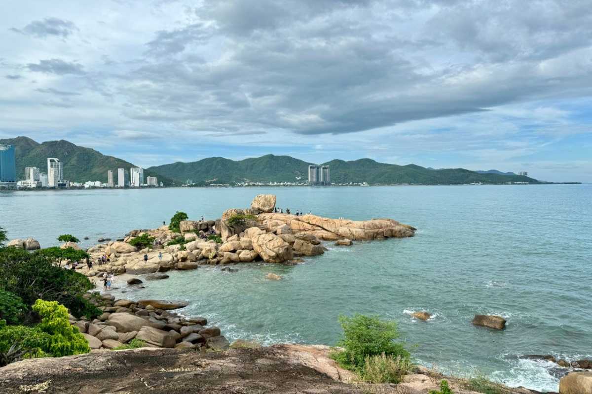Da Chong Wharf Rocky Shoreline and Hills Nha Trang Rocky shoreline with lush green hills in the background at Da Chong Wharf, Nha Trang