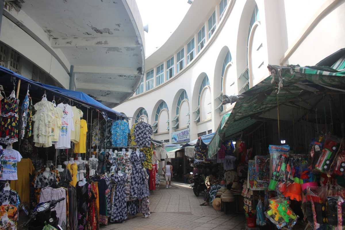 Colorful clothes and garments inside Dam Market Nha Trang Interior view of Dam Market Nha Trang showing vibrant clothing stalls with a variety of traditional and casual wear