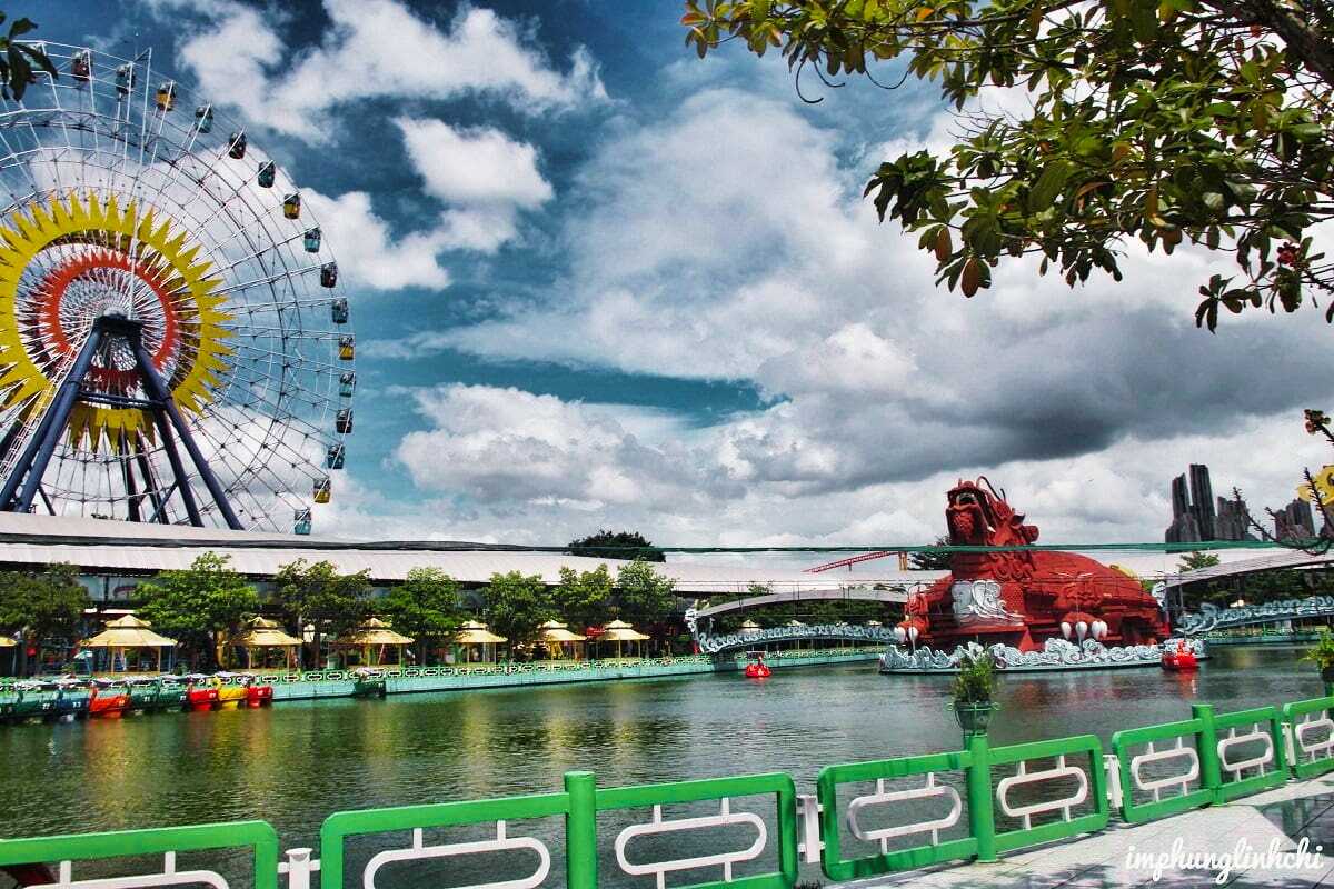 Ferris Wheel and Dragon Bridge over Lake at Dam Sen Ferris wheel and decorative dragon bridge spanning the lake inside Dam Sen Water Park