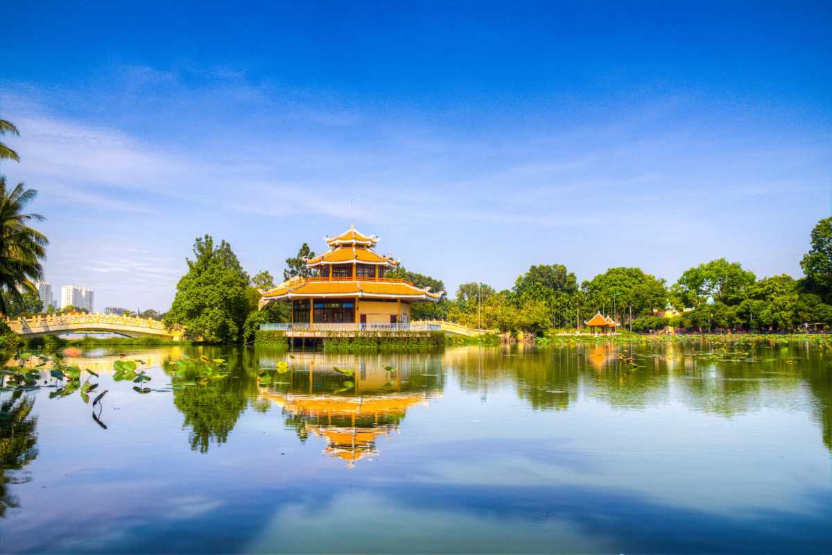 Peaceful Pavilion Reflected in Lake at Dam Sen Traditional pavilion reflected in calm lake waters surrounded by trees at Dam Sen Water Park