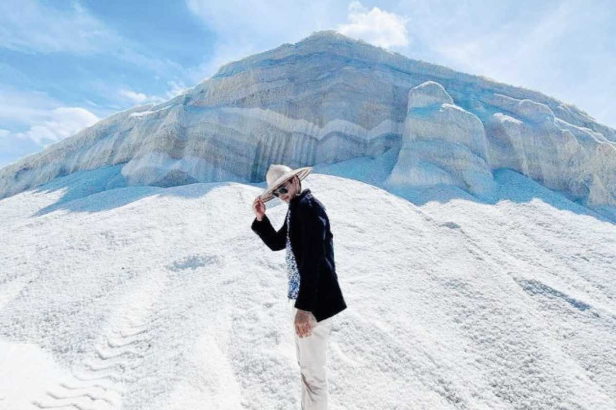 Dam Vua Salt Fields Visitor on Salt Mounds Visitor standing on large salt mounds at Dam Vua Salt Fields Ninh Thuan