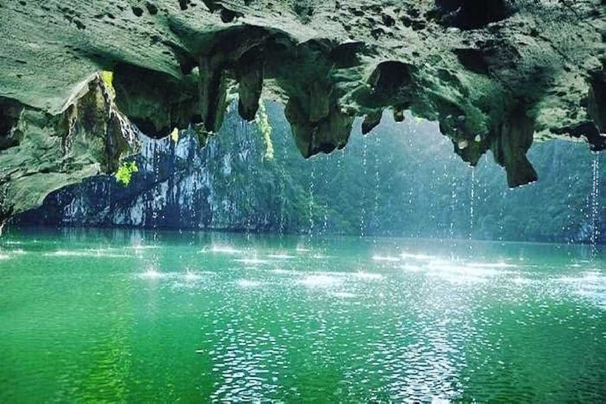 Dark and Bright Cave Halong Bay sparkling water drops Sunlight streams through the cave roof at Dark and Bright Cave Halong Bay, catching water drops and sparkling on the lagoon.
